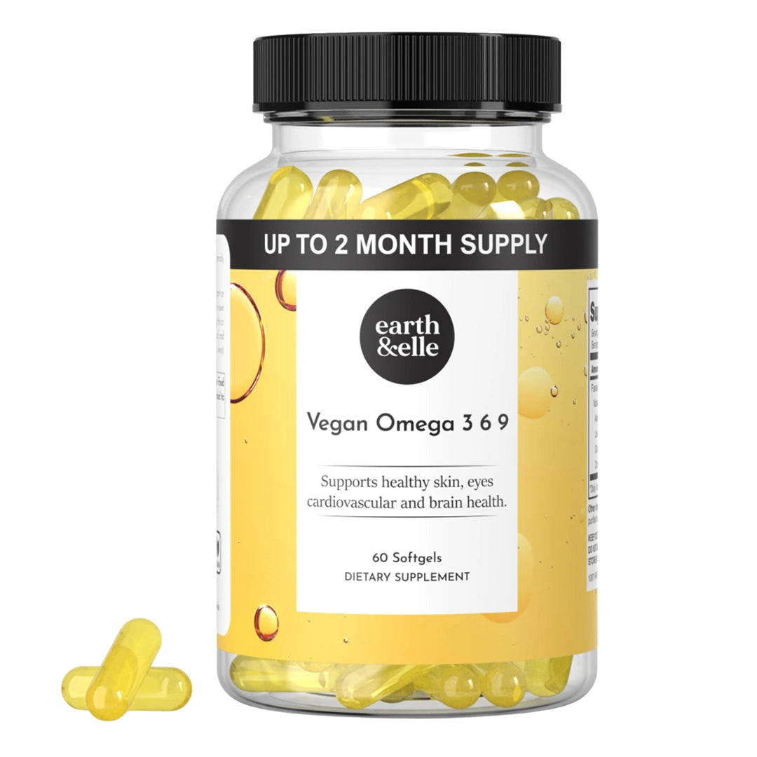 Close-up of Earth & Elle Vegan Omega 3 softgel supplement bottle with yellow softgels inside. The label mentions “Supports healthy skin, eyes, cardiovascular and brain health.” The black band across the top states “UP TO 2 MONTH SUPPLY.”