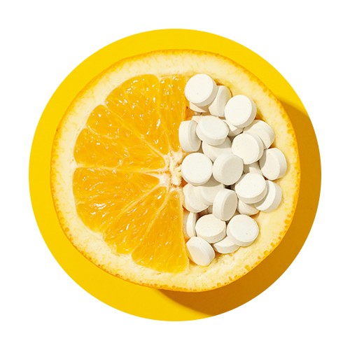 Half orange filled with white Vitamin C tablets on a bright yellow background